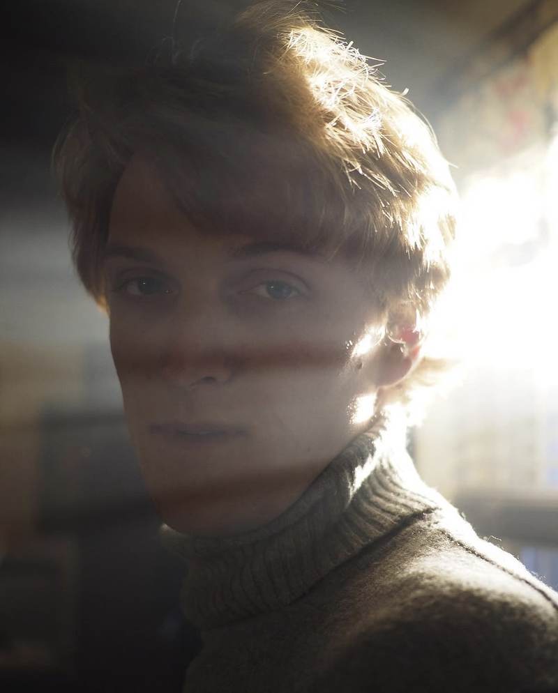 Collin Westerlund in a turtleneck, backlit by window light