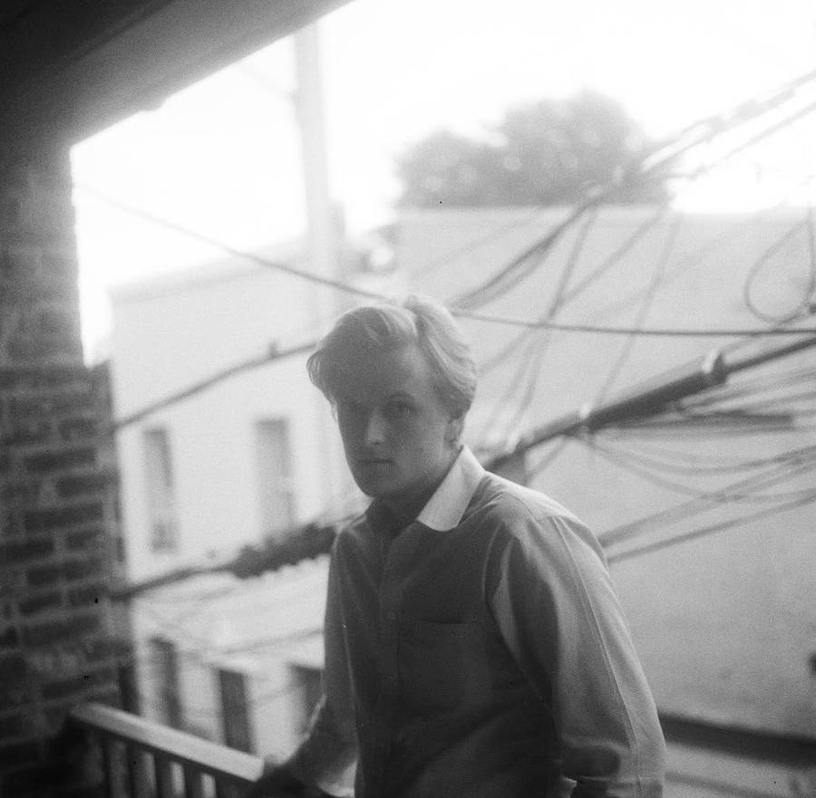 Black and white portrait on a balcony among power lines