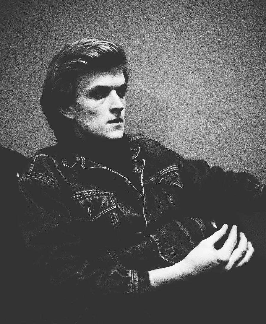 High-contrast black and white portrait in a denim jacket