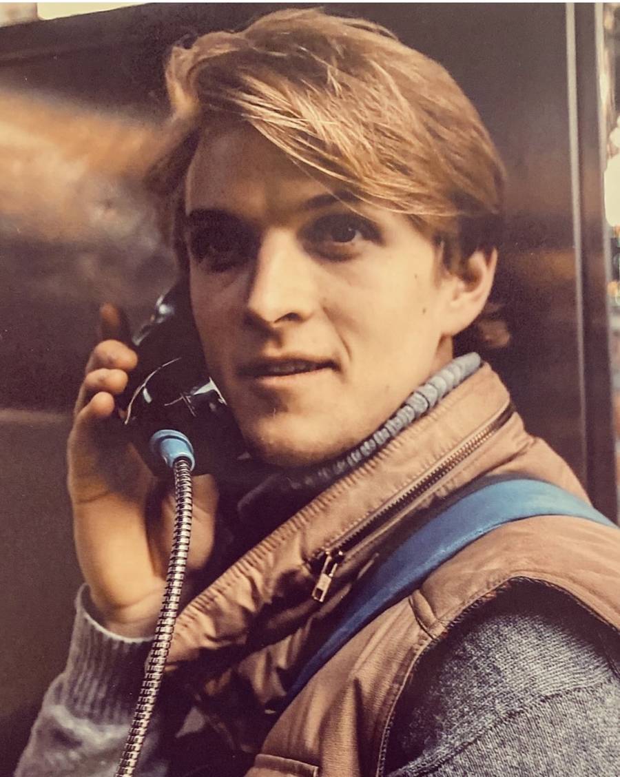 On a payphone in a warm-toned city shot